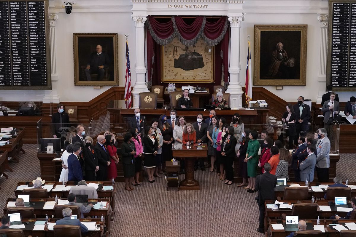 In this May 5, 2021 photo, Texas state Rep. Donna Howard, D-Austin, center at lectern, stands with fellow lawmakers in the House Chamber in Austin, Texas, as she opposes a bill introduced that would ban abortions as early as six weeks and allow private citizens to enforce it through civil lawsuits, under a measure given preliminary approval by the Republican-dominated House. A Texas law banning most abortions in the state took effect at midnight on Sept. 1 but the Supreme Court has yet to act on an emergency appeal to put the law on hold. If allowed to remain in force, the law would be the most dramatic restriction on abortion rights in the United States since the high court’s landmark Roe v. Wade decision legalized abortion across the country in 1973.  (Eric Gay)