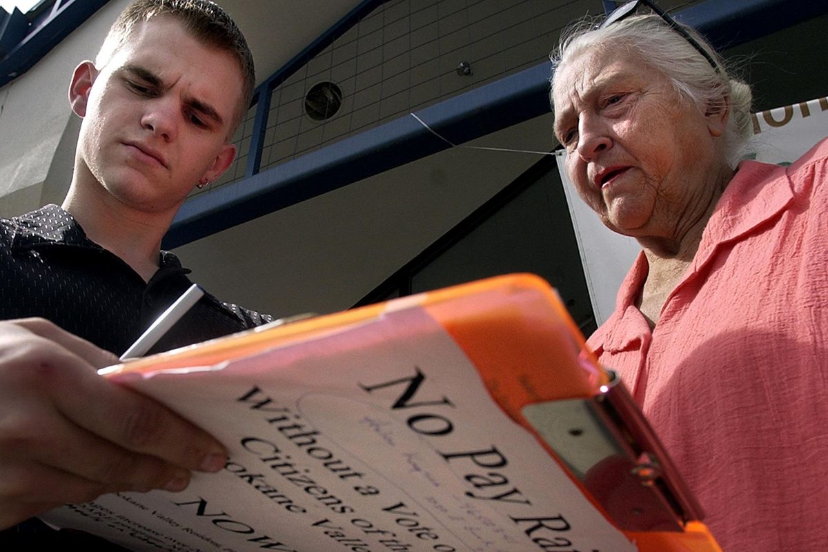 FILE – Sally Jackson, right, working on her petition drive in 2004 to stop a proposed pay increase to Spokane Valley City Council members (Liz Kishimoto / The Spokesman-Review)