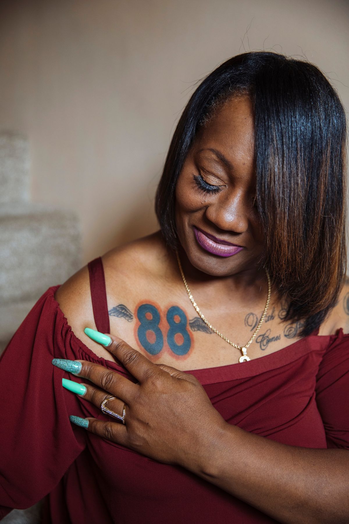 Katina Smith, the mother of Demaryius Thomas, shows the tattoos she had to honor her son, in Dublin, Ga., on June 29, 2022. Thomas had chronic traumatic encephalopathy when he died in December at 33, but the posthumous diagnosis alone does not explain what role football had in the charismatic NFL star's quick decline. (Kendrick Brinson/The New York Times).  (KENDRICK BRINSON)