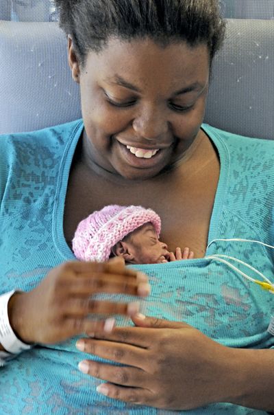 Linda Forbes holds her daughter last month in Miami in the “kangaroo,” which gives skin-to-skin contact that benefits premature babies. Grace was born weighing barely more than 2 pounds.