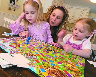 
Michelle Hastings, center, plays Candy Land with her daughters Campbell Hastings, 5, left, and Peyton Hastings, 2, right, in Holliston, Mass. 
 (Associated Press / The Spokesman-Review)