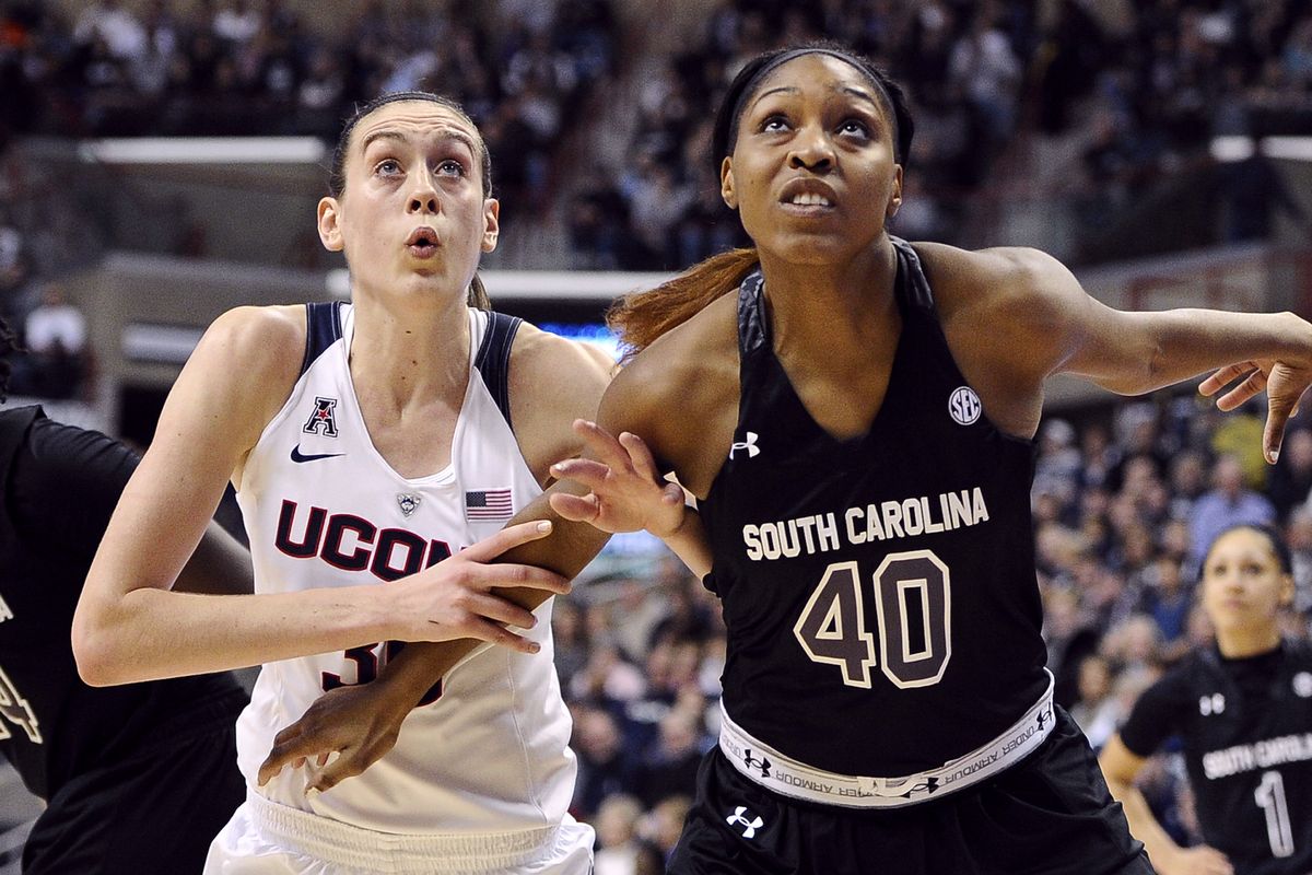 Connecticut’s Breanna Stewart and South Carolina’s Jatarie White jostle for position as they eye a rebound Monday night. (Associated Press)