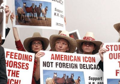 
Demonstrators carry signs during a rally on Capitol Hill in Washington on Tuesday in support of a bill to ban horse slaughter for human consumption. The House is scheduled to consider the bill this week. 
 (Associated Press / The Spokesman-Review)