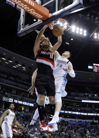 Trail Blazers center Robin Lopez dunks over Denver’s Jusuf Nurkic for two of his 15 points in the first half. Lopez finished with 19. (Associated Press)