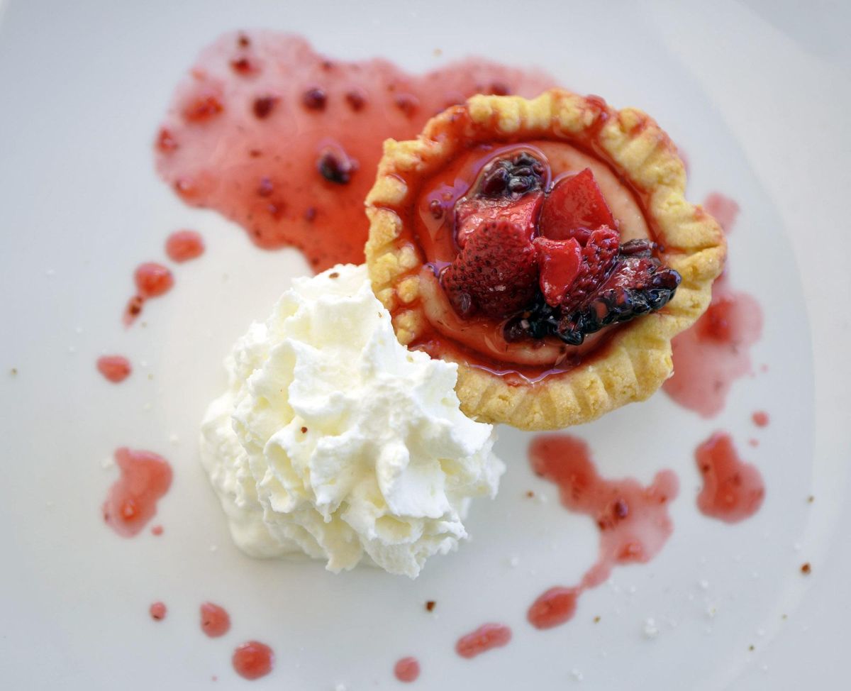 Clover purposefully offers downsized desserts meant to be a small and sweet bite or two after a full meal. Pictured here is the key lime tart topped with mixed berries and served with a dollop of Chantilly cream. (Adriana Janovich / The Spokesman-Review)