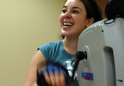 
Jamie Babin, 21, of Bonners Ferry, laughs during a workout at North Idaho Advanced Care hospital in Post Falls on Tuesday. She was injured in a plane crash five years ago but surprised  her family Thursday by returning home early from her latest round of treatment. 
 (Kathy Plonka / The Spokesman-Review)