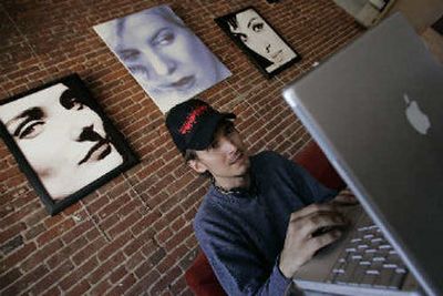 
Topher Hopkins listens to music on iTunes on his Apple Powerbook laptop Wednesday, in Eagle Rock, Calif. The major recording companies have begun taking steps to legitimize peer-to-peer, or P2P technology. 
 (Associated Press / The Spokesman-Review)