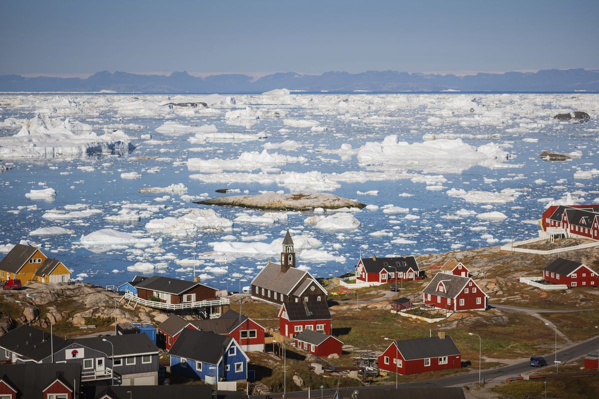 The town of Ilulisat in Greenland on Sept. 2, 2021. The Arctic island, renowned for its glaciers and fjords, is expanding airports and hotels to energize its economy, even as it tries to avoid the pitfalls of overtourism.  (CARSTEN SNEJBJERG/New York Times)