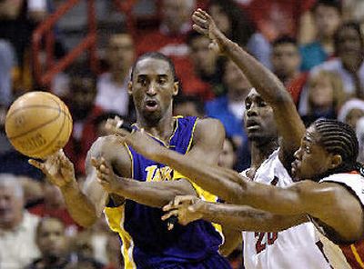 
Kobe Bryant passes as Miami's Gary Payton and Udonis Haslem defend.
 (Associated Press / The Spokesman-Review)