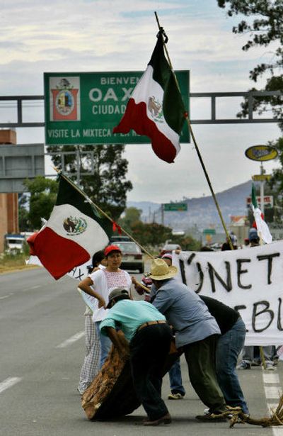 
Supporters of the Popular Assembly of the People of Oaxaca block a highway in Oaxaca City in Mexico on Saturday. 
 (Associated Press / The Spokesman-Review)