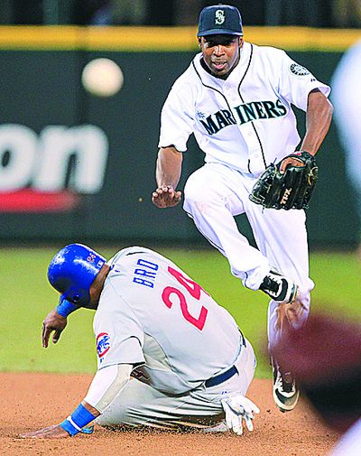 M’s Chone Figgins jumps out of way of Marlon Byrd while turning two in eighth. (Associated Press)
