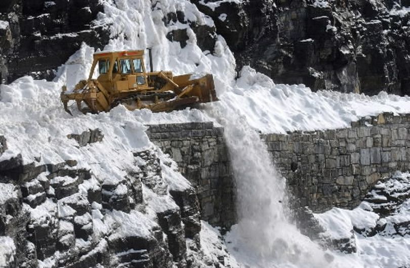 A bulldozer clears snow off Going to the Sun Road, Wednesday, April 13, 2005, in Montana's Glacier National Park. Park road crews are currently two weeks ahead of schedule in the annual clearing of the high altitude road that crosses the Continental Divide.  (Associated Press)