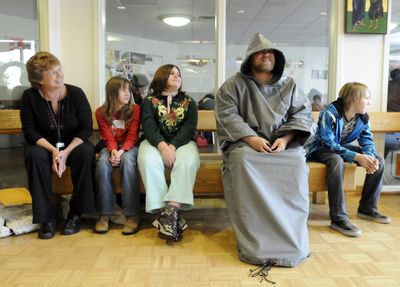 Rich Atwood wears a combination coat and sleeping bag Monday at the House of Charity in Spokane. The coat was designed by the students of West Valley City School’s Kathy Braid, left, including  Melody Fyre,  second from left, Skye Reynolds, center, and Jared Lord, far right.  (Jesse Tinsley / The Spokesman-Review)