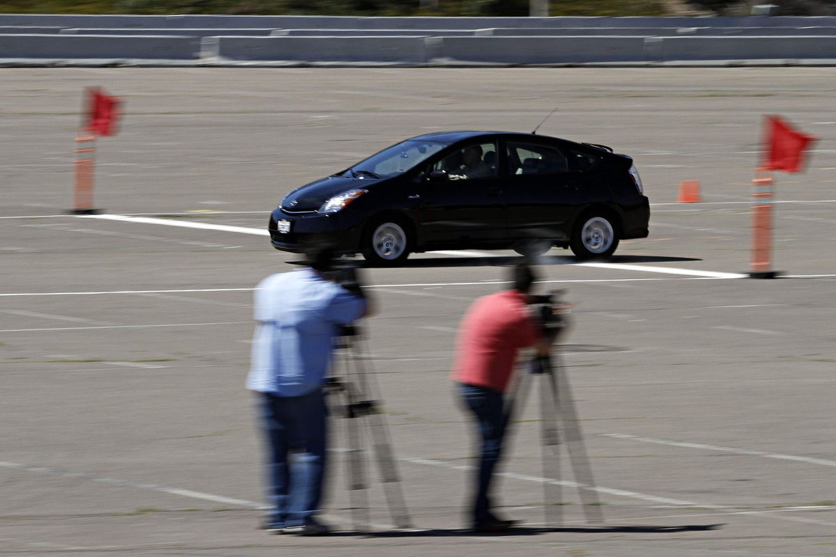 Television cameramen look on as a 2008 Toyota Prius’ brakes are tested after a news conference held Monday in San Diego. Toyota held the news conference to share preliminary findings of the company’s technical investigation into an alleged incident of unintended acceleration, involving a 2008 Toyota Prius driven by James Sikes. (Associated Press)