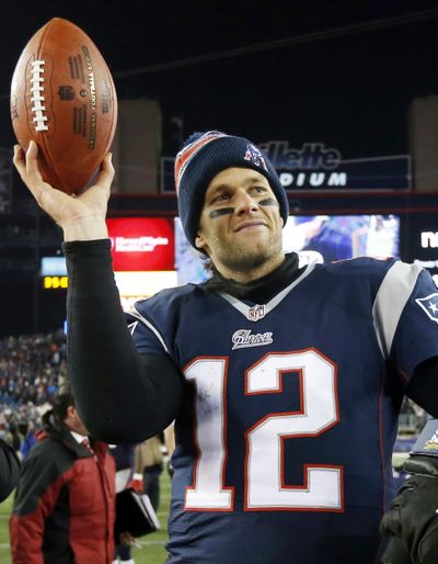 In this Jan. 10, 2015, photo, New England Patriots quarterback Tom Brady holds up the game ball after an NFL divisional playoff football game against the Baltimore Ravens in Foxborough, Mass. On Wednesday, a federal appeals court rejected Tom Brady's attempt to get a new hearing on his suspension. (Elise Amendola / Associated Press)