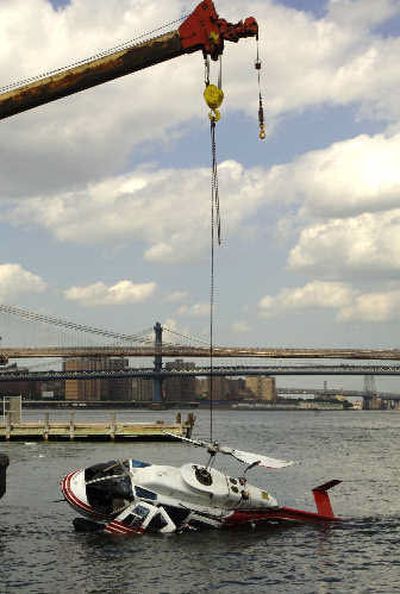 
A helicopter is lifted from the East River by an Army Corps of Engineers salvage boat off lower Manhattan in New York on Tuesday. The craft, carrying tourists on a sightseeing trip, crashed Tuesday just minutes after taking off, authorities said. 
 (Associated Press / The Spokesman-Review)