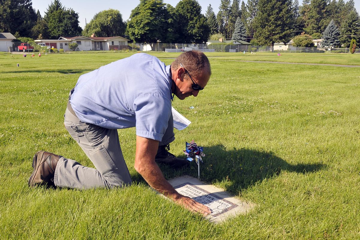 Steve Pratt, a groundskeeper at Pines Cemetery in Spokane Valley, checks a headstone before digging a hole for the burial of cremated remains on Aug. 7. His grounds crew also maintains South Pines and Woodlawn cemeteries. (Jesse Tinsley)