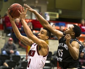 Eastern Washington Eagles guard Drew Brandon (22) heads to the basket as Portland State Vikings guard Marcus Hall (15) defends during the second half of a college basketball game, Monday, Feb. 24, 2014, at Eastern Washington University in Cheney, Wash. (Colin Mulvany / The Spokesman-Review)