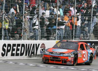 
Fans cheer as Jeff Burton crosses the finish line to win the NASCAR Sprint Cup Series Food City 500. Associated Press
 (Associated Press / The Spokesman-Review)