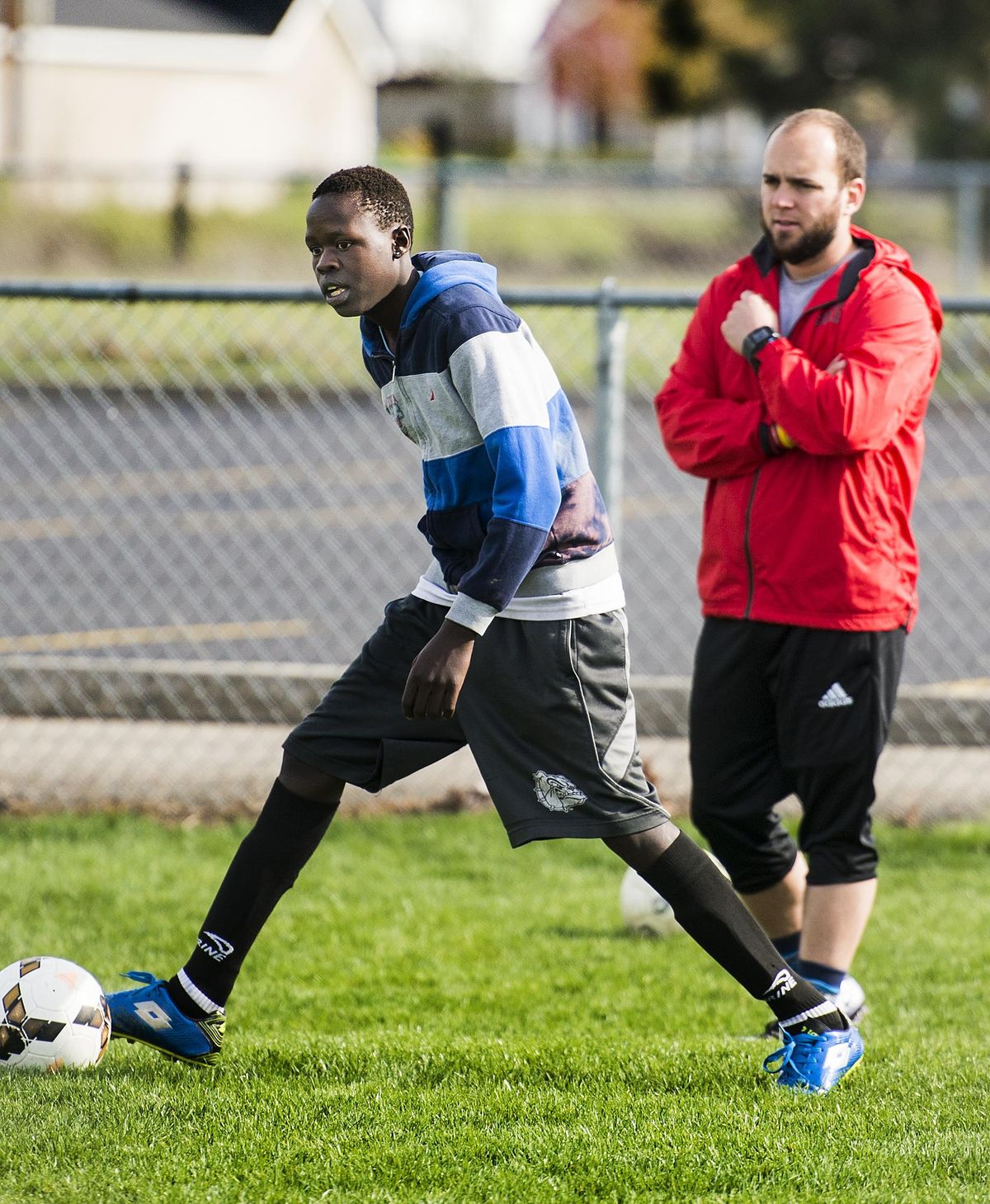 A English Language Development program teacher at Ferris, Alex Bray, right, also coaches soccer to immigrants like Akir Lual, a 16-year-old native of South Sudan whose family moved to a camp in Ethiopia when Lual was an infant. He arrived in Spokane two years ago. COLIN MULVANY colinm@spokesman.com (Colin Mulvany / The Spokesman-Review)