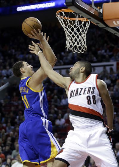 Golden State’s Klay Thompson goes to the hoop against Portland’s Nicolas Batum in the first half. Thompson finished with 29 points. (Associated Press)