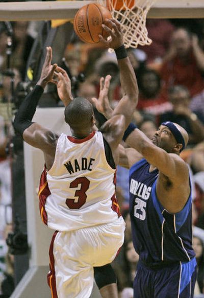 
Miami's Dwyane Wade (3) scores two of his 31 points as Erick Dampier of Dallas defends.
 (Associated Press / The Spokesman-Review)