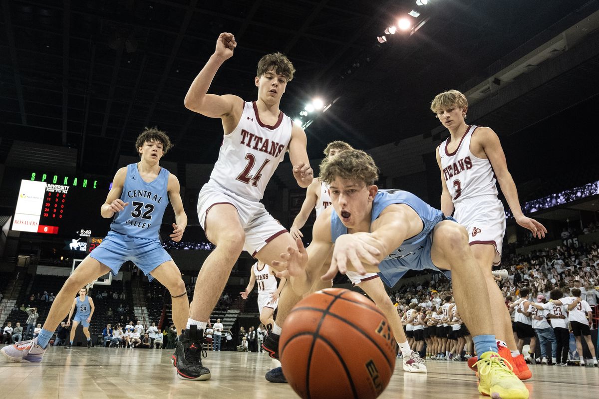 Central Valley guard Brennan Brulotte chases a loose ball out of bounds as University’s defense watches during the rivalry game Thursday at the Arena.  (Colin Mulvany/The Spokesman-Review)
