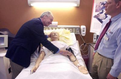 
Idaho Gov. Dirk Kempthorne laughs when a mannequin begins coughing in the new North Idaho College Health and Sciences building Thursday, just prior to the grand opening ceremonies. 