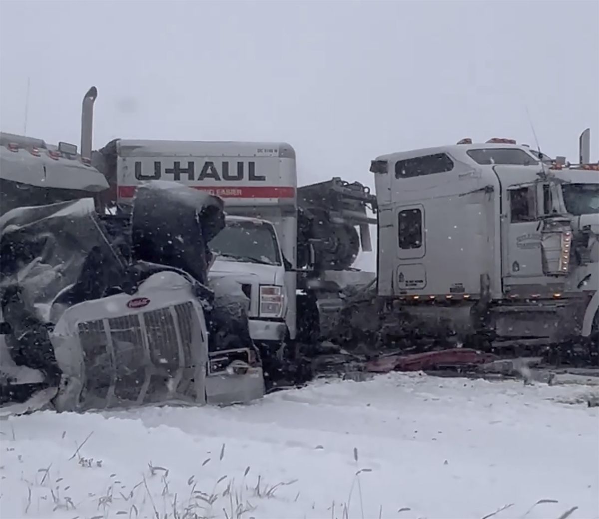 This image from video provided by David Troesser shows a pileup involving about 100 cars, trucks and big rigs during a blinding snowstorm on Interstate 39 north of Bloomington, Ill,. on Thursday, Feb. 17, 2022. There were no reports of injuries in the crashes, which happened as winds gusting up to 40 mph (64 kph) cut visibility during a storm that swept through the Midwest and other parts of the country. (HONS)