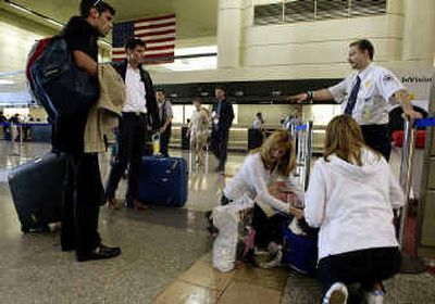 
An unidentified Transportation Security Administration screener directs passengers at Los Angeles International Airport.
 (File/Associated Press / The Spokesman-Review)