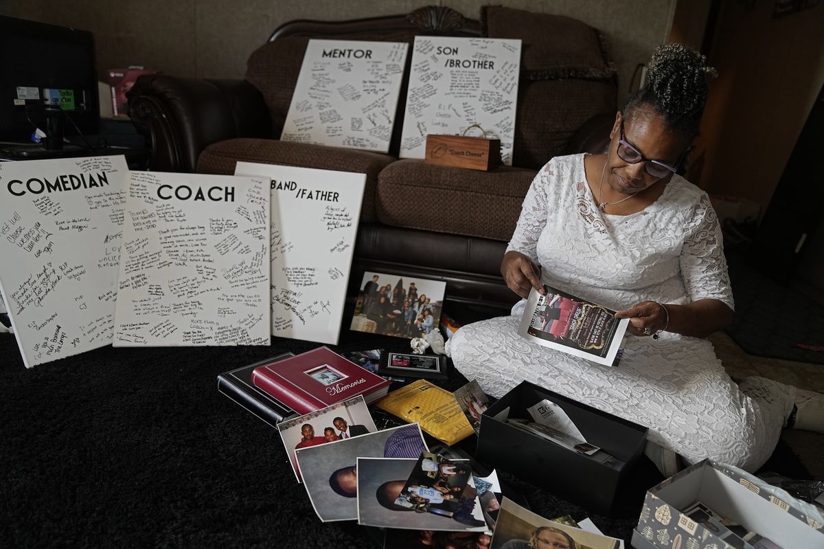 Carolyn Burnett sorts through mementos to select items to commemorate her son Chris Burnett on Dec. 5 in Olathe, Kan.  (Charlie Riedel)