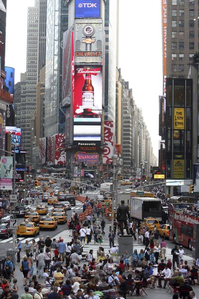 Pedestrians and traffic make their way through New York’s Times Square on Friday. The collision of avenues helped name this place the “Crossroads of the World.”  (Associated Press / The Spokesman-Review)