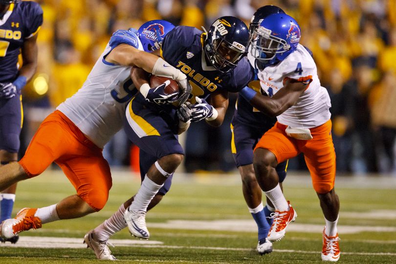 Toledo wide receiver Eric Page, center, is tackled by Boise State linebacker Byron Hout, left, and cornerback Jerrell Gavins, right, in the second quarter of an NCAA college football game in Toledo, Ohio, Friday, Sept. 16, 2011. (Rick Osentoski / Fr170444 Ap)