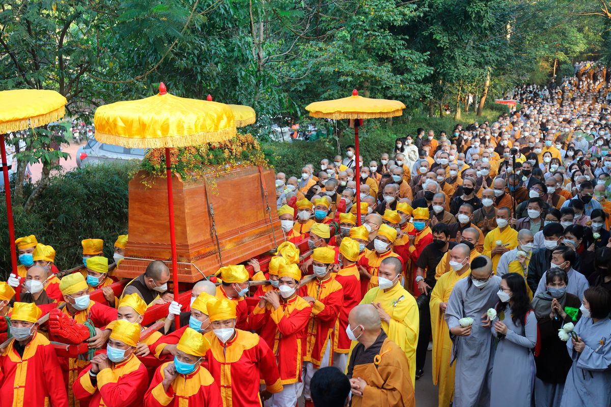 Coffin of Vietnamese Buddhist monk Thich Nhat Hanh is carried to the street during his funeral in Hue, Vietnam Saturday, Jan. 29, 2022. A funeral was held Saturday for Thich Nhat Hanh, a week after the renowned Zen master died at the age of 95 in Hue in central Vietnam.  (Thanh Vo)