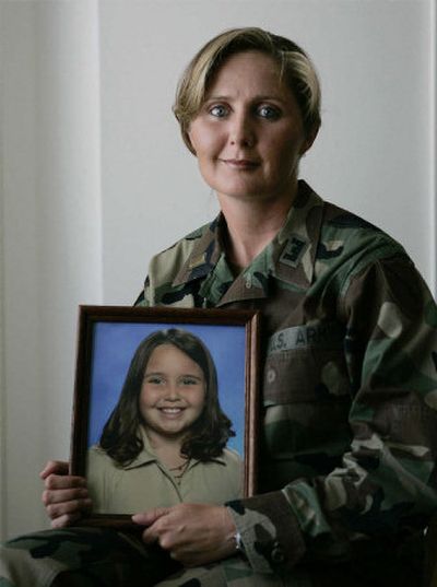 
Lt. Eva Crouch holds a 2004 photo of her daughter, Sara, at her home in Lawrenceburg, Ky., in 2005. 
 (File Associated Press / The Spokesman-Review)