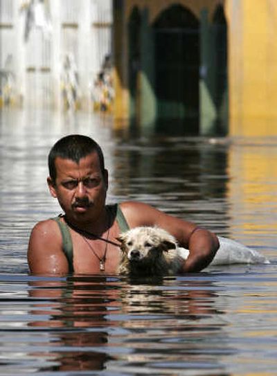 
A man wades through a flooded street in Villahermosa, Mexico, on Tuesday.Associated Press
 (Associated Press / The Spokesman-Review)
