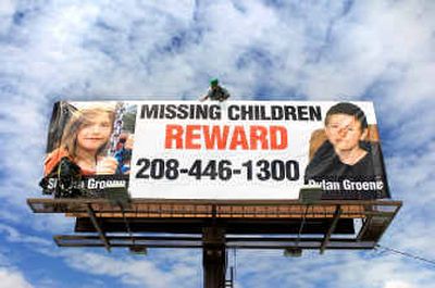 
 Lamar Outdoor Advertising workers install a billboard Friday at Helena and Sprague in Spokane about Shasta and Dylan Groene. Lamar is donating two signs in Spokane and one in Idaho. 
 (Colin Mulvany / The Spokesman-Review)