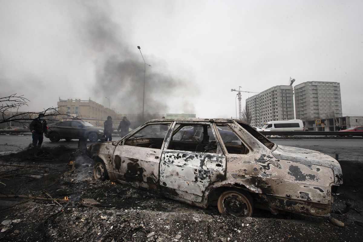 A car, which was burned after clashes, is seen on a street in Almaty, Kazakhstan, Friday, Jan. 7, 2022. Kazakhstan