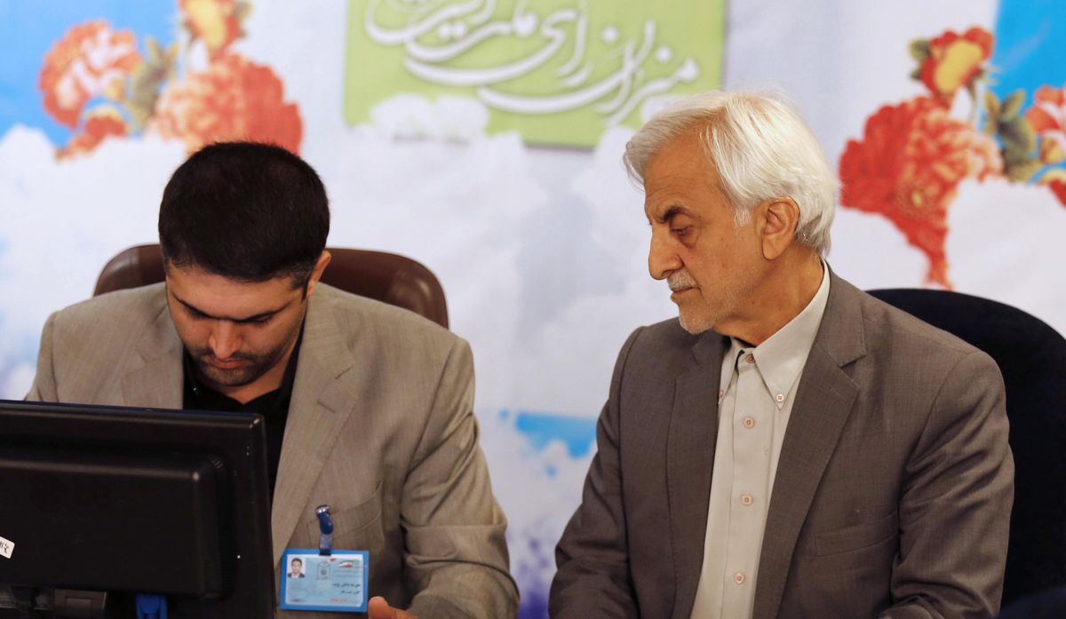 In this picture taken on Thursday, April 13, 2017, former Iranian pro-reform Vice President Mostafa Hashemitaba, right, a candidate for the May 19 presidential elections, attends at the Interior Ministry to register his candidacy, in Tehran, Iran. An Iranian panel charged with vetting candidates approved the country’s incumbent president and five challengers but disqualified former hard-line President Mahmoud Ahmadinejad from running in next month’s presidential election, state television reported Thursday April 20, 2017. (STR / Associated Press)