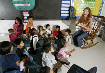 
Teacher Jennifer Carothers leads her pre-kindergarten class in song at an elementary school in Sicklerville, N.J., on June 29. Students at the school are the children of migrant workers, most of whom work in the area's seasonal blueberry industry. 
 (Associated Press photos / The Spokesman-Review)