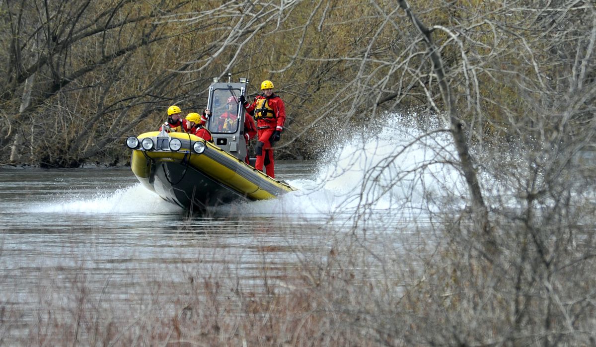 Spokane Fire Department Water Rescue Team patrols the Spokane River along Upriver Drive after witnesses reported a person in the water near Greene Street Bridge, Tuesday morning, April 10, 2012.  The search was called off. (Dan Pelle / The Spokesman-Review)