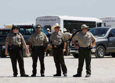 
Officers stand outside the Eldorado Civic Center  in  Texas, where children taken from a nearby polygamist compound were brought. Associated Press
 (Associated Press / The Spokesman-Review)
