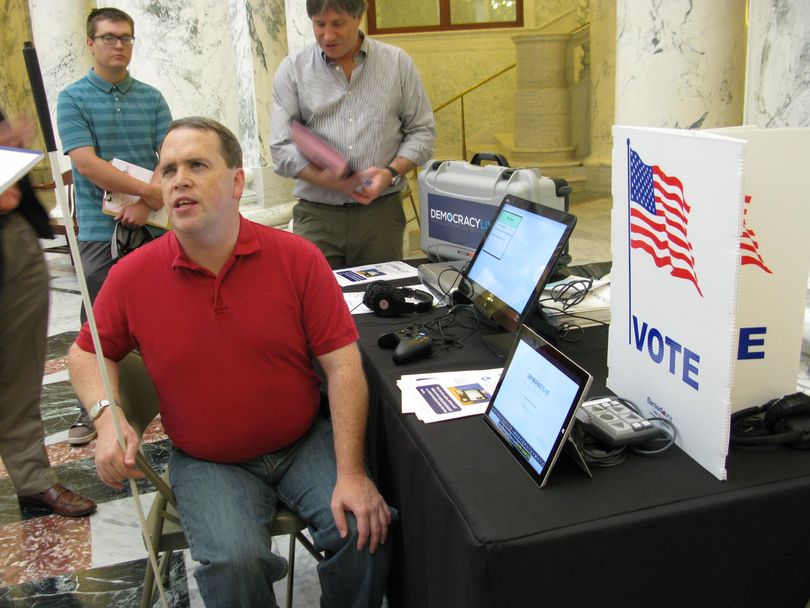 Mike Gibson, who is blind, talks about a new voting machine he tried out at the Capitol on Friday. 
