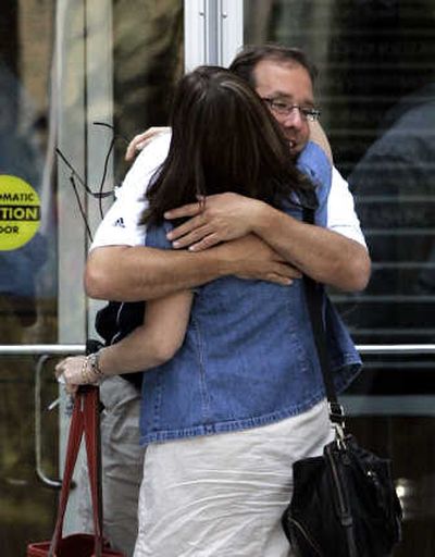 
Employees hug as they leave the headquarters of American Home Mortgage Investment Corp. in Melville, N.Y., on Friday. Associated Press
 (Associated Press / The Spokesman-Review)
