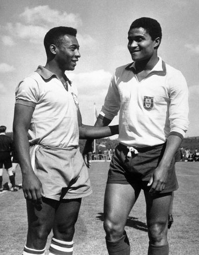 In 1963 photo, Brazilian soccer star Pele, left, chats with Portuguese star Eusebio, who died Sunday. (Associated Press)