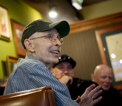 Tom Wobker, aka the Bard of Sherman Avenue, center smiles after being being revealed during Blogfest 2016 on Saturday, Feb. 20, 2016, at in Coeur d'Alene. (Tom Tjomsland/THE SPOKESMAN-REVIEW)