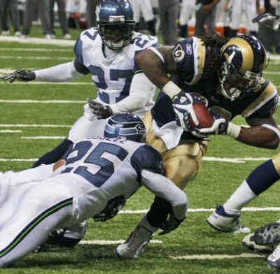 
Seattle safety Brian Russell stops St. Louis running back Steven Jackson during Nov. 25 game. Associated Press
 (Associated Press / The Spokesman-Review)