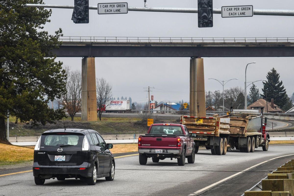 Motorists drive under the ramp meter, similar looking to a traffic signal, where northbound U.S. Highway 195 joins eastbound I-90, on Friday, March 29, 2019. The meter goes into operation on April 9. (Dan Pelle / The Spokesman-Review)