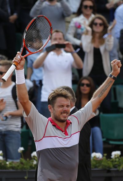 Stan Wawrinka raises arms in triumph at French Open on Tuesday. (Associated Press)