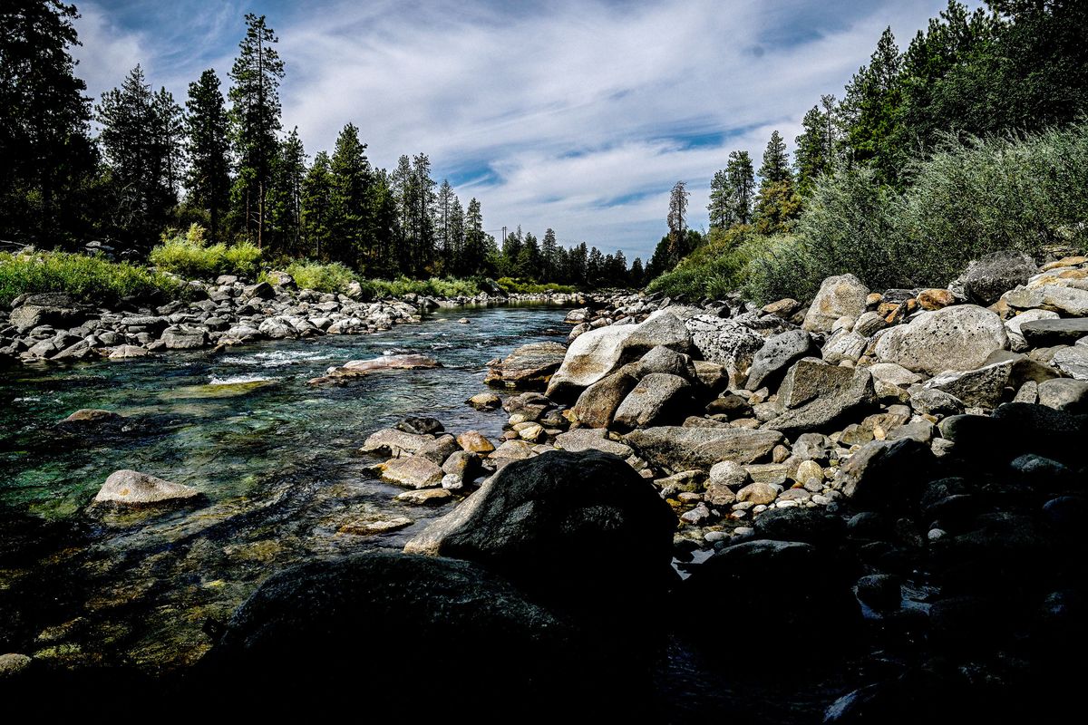 Exposed rocks reveal the normal waterline Monday in the Spokane River below the Sullivan Street bridge in Spokane Valley.  (Kathy Plonka/The Spokesman-Review)